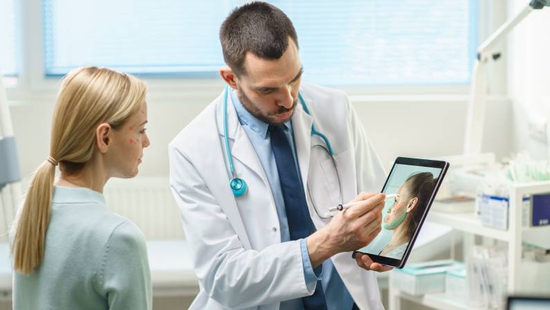 Cosmetic Surgeon Consults Woman about Facial Lift Surgery