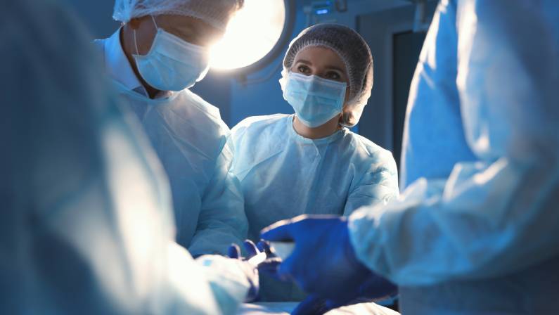 Team of professional surgeons performing operation