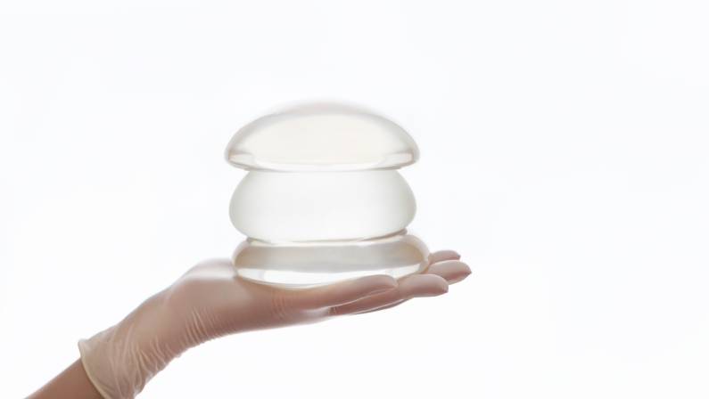 Silicone breast implant on hands
