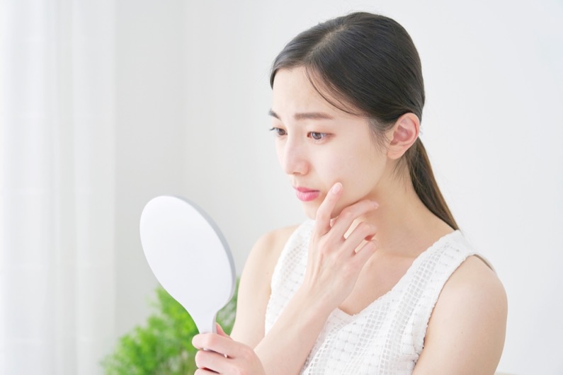 Asian woman looking in the mirror