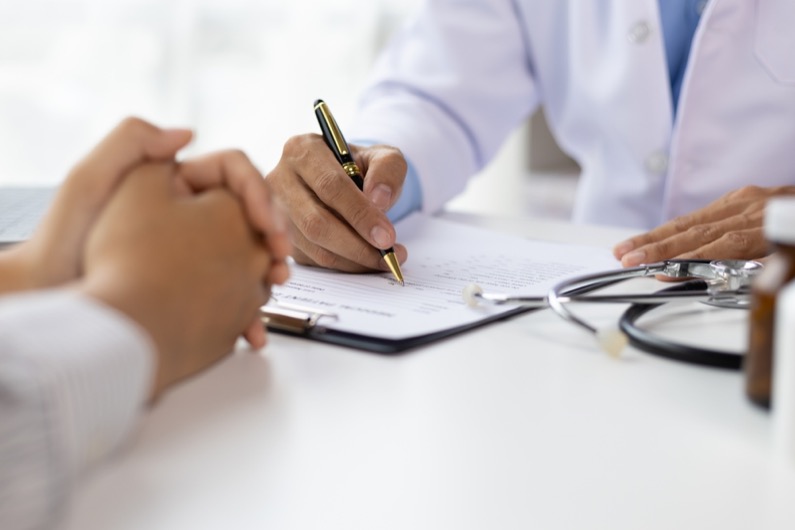Doctor diagnosing a woman's illness in a hospital examination room, disease treatment from specialists. Medical treatment and health consultation. General health checkups and women's health problems.