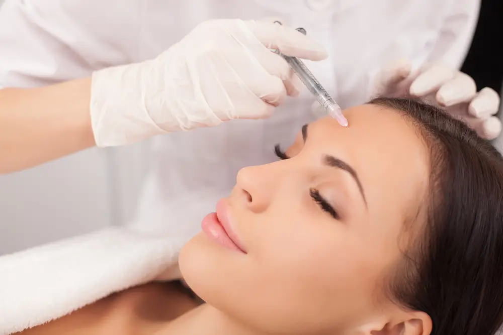 Woman receiving Botox Forehead Injection Sites treatment to smooth fine lines and achieve a refreshed, youthful look.