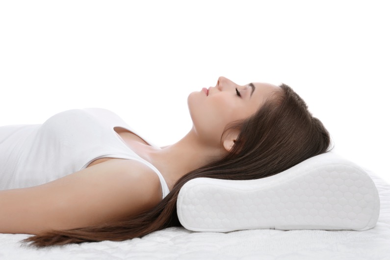 Woman resting on her back after Otoplasty, Ear Pinning Surgery, keeping her head elevated for proper healing and comfort.