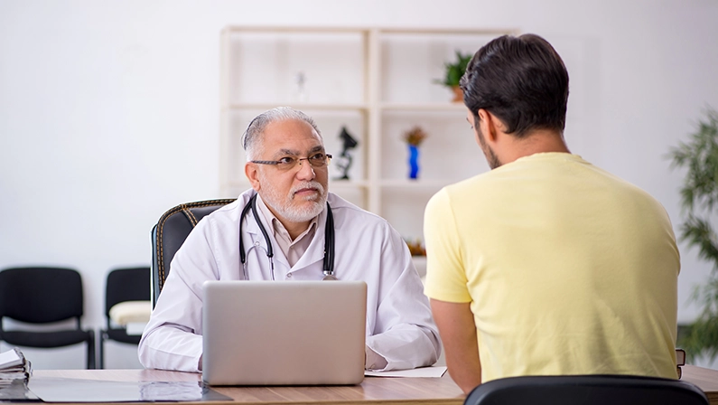 Young male patient visiting old male doctor