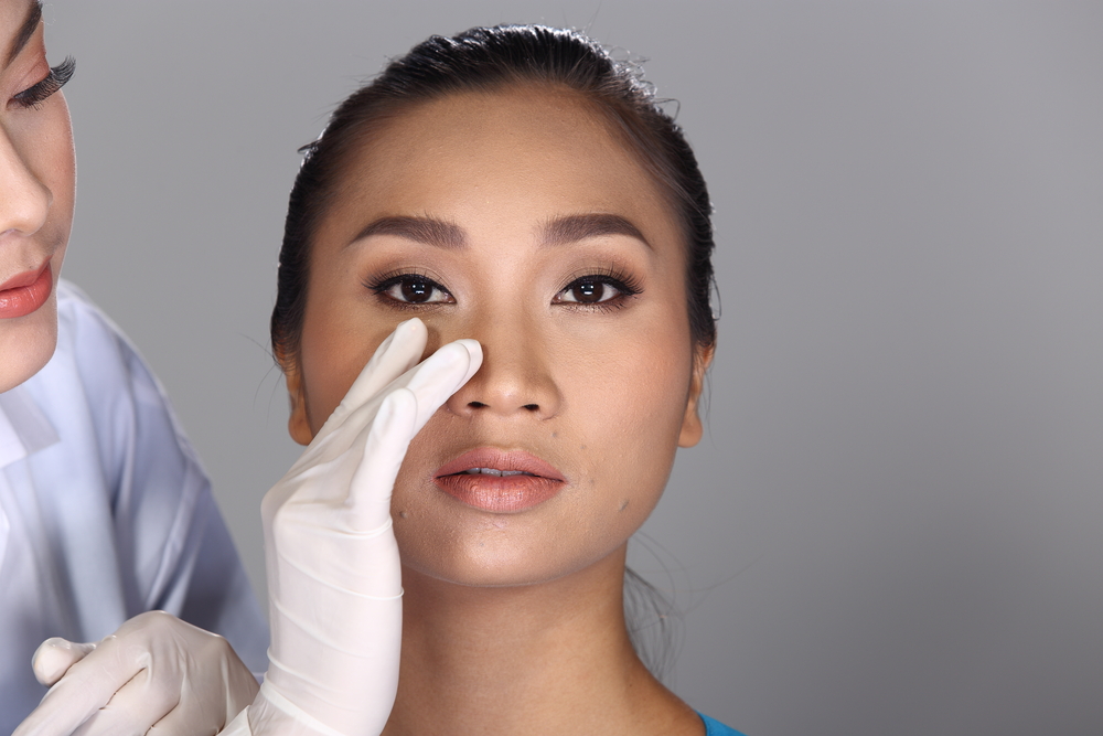 Asian Doctor Nurse check face nose structure before plastic surgery